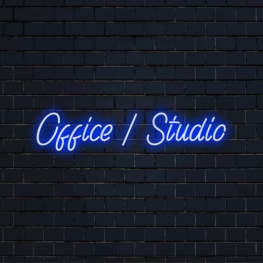 Office Studio Neon Light with glowing wall decor against brick backdrop