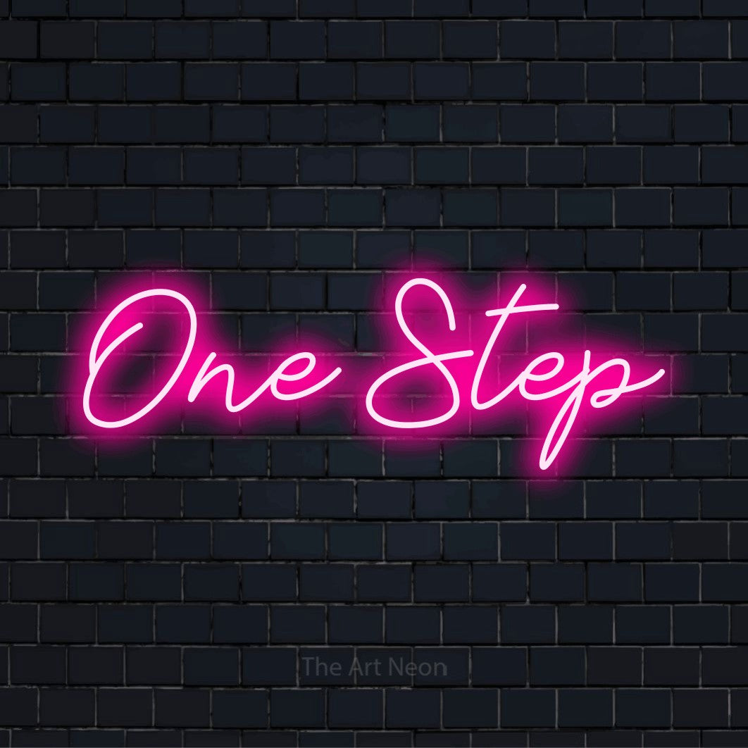 "One Step" neon text design on a black brick wall