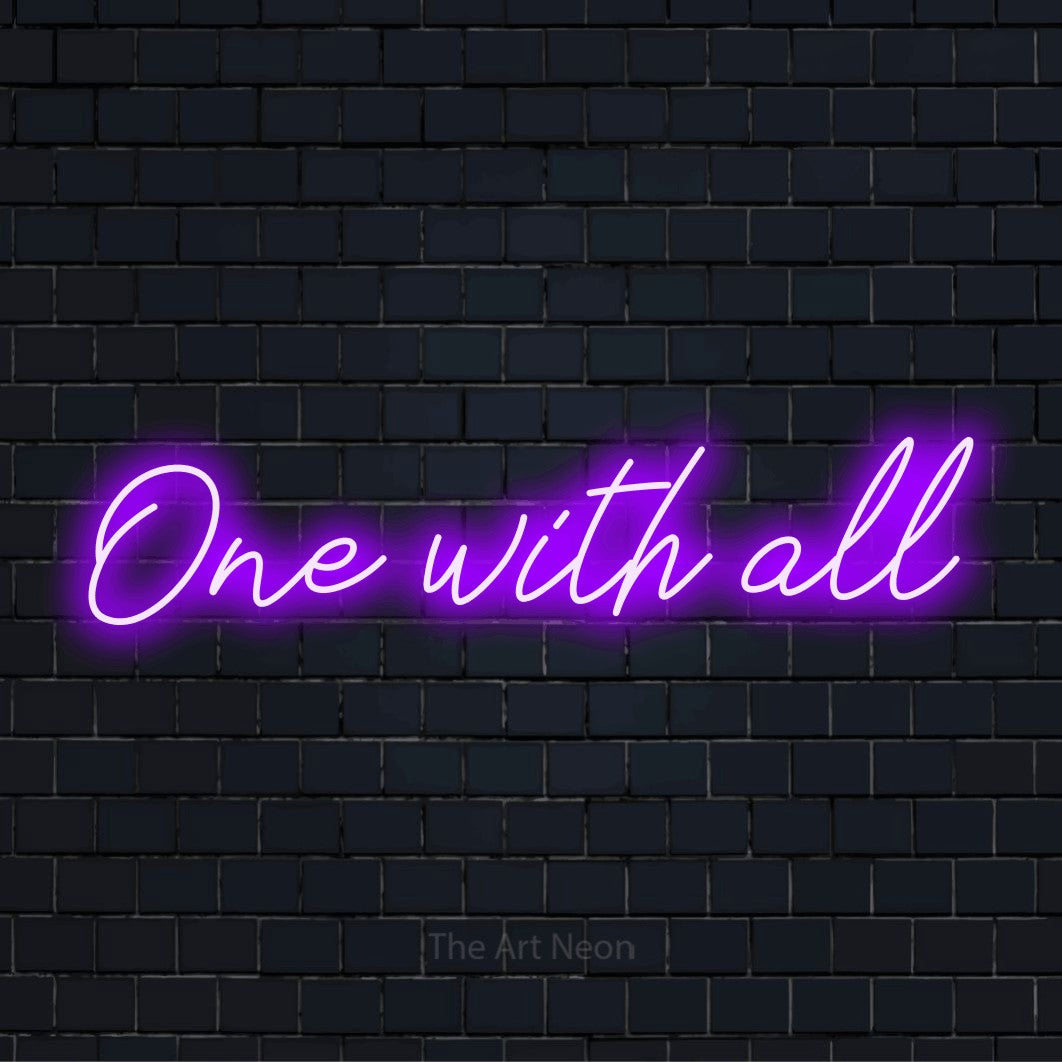 "One With All" script-style LED neon sign on a black brick wall