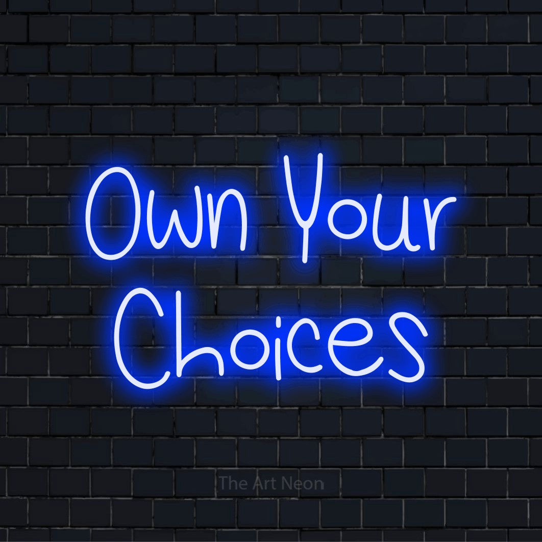 "Own Your Choices" glowing LED neon sign on a black brick wall