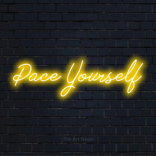 "Pace Yourself" neon text design on a black brick wall