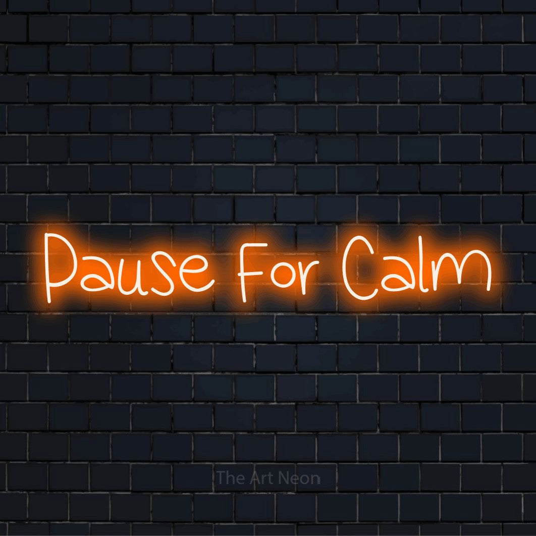 "Pause For Calm" neon text design on a black brick wall