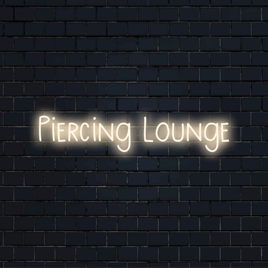 Piercing Lounge Neon Sign, glowing lettering on dark brick background
