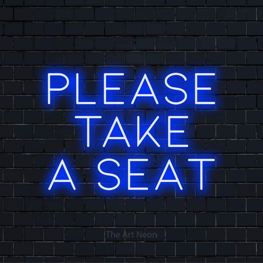 "Please Take A Seat" glowing LED neon sign on a black brick wall