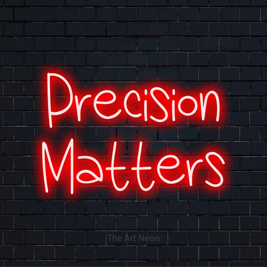 "Precision Matters" text design with neon effect on a black brick wall