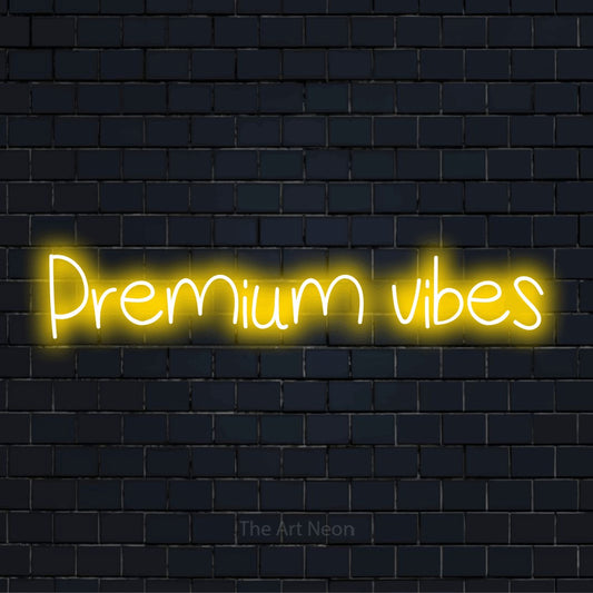 "Premium Vibes" script-style LED neon sign on a black brick wall