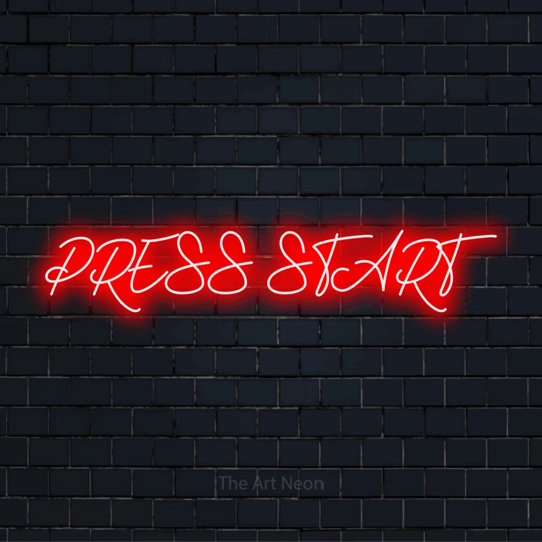 "Press Start" glowing LED neon sign on a black brick wall