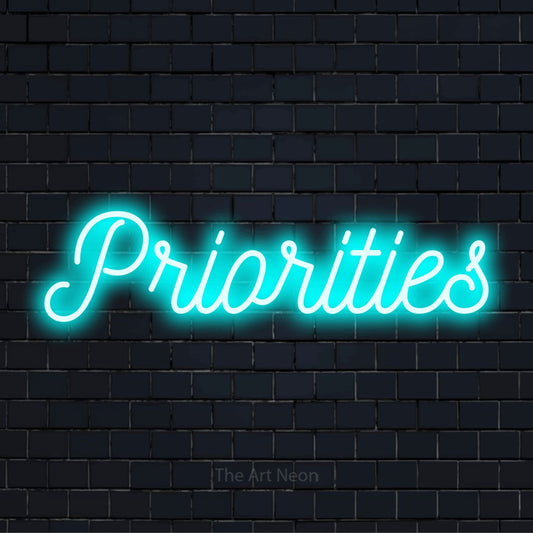 "Priorities" LED neon sign on a black brick wall