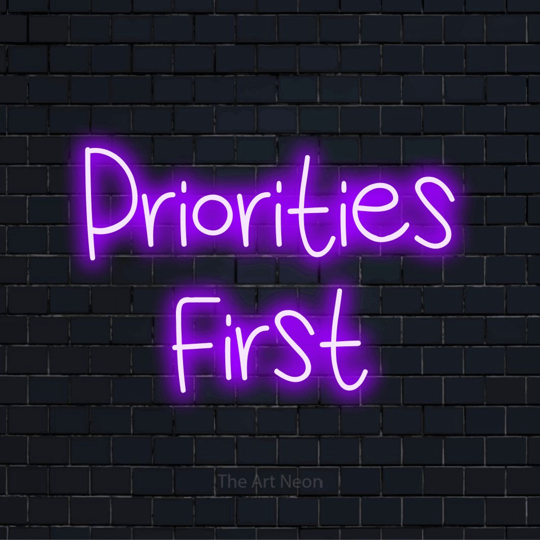"Priorities First" text design with neon effect on a black brick wall