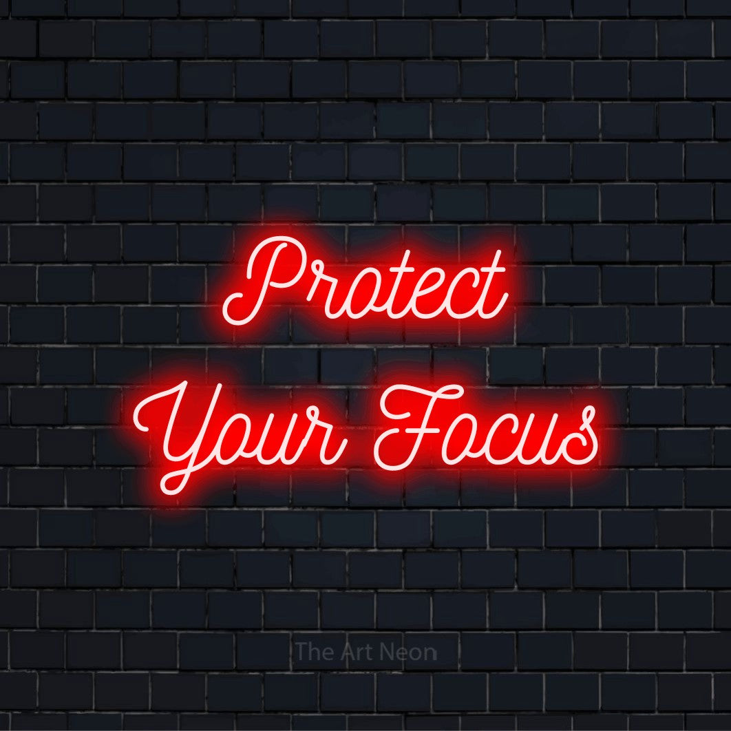 "Protect Your Focus" LED neon sign on a black brick wall