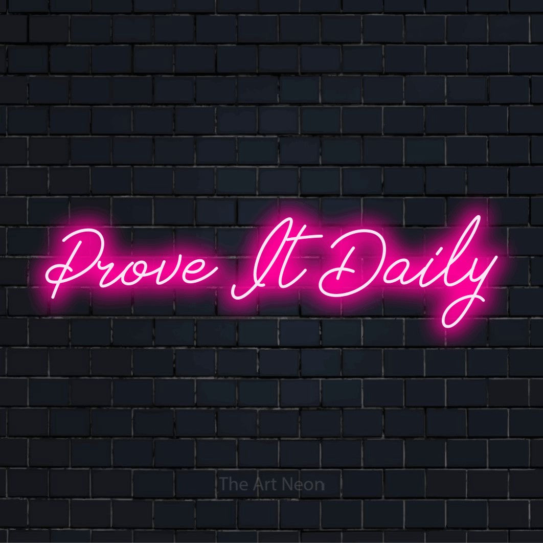 "Prove It Daily" glowing LED neon sign on a black brick wall