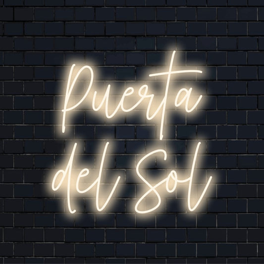 Puerta Del Sol Neon Sign, glowing lettering on dark brick background
