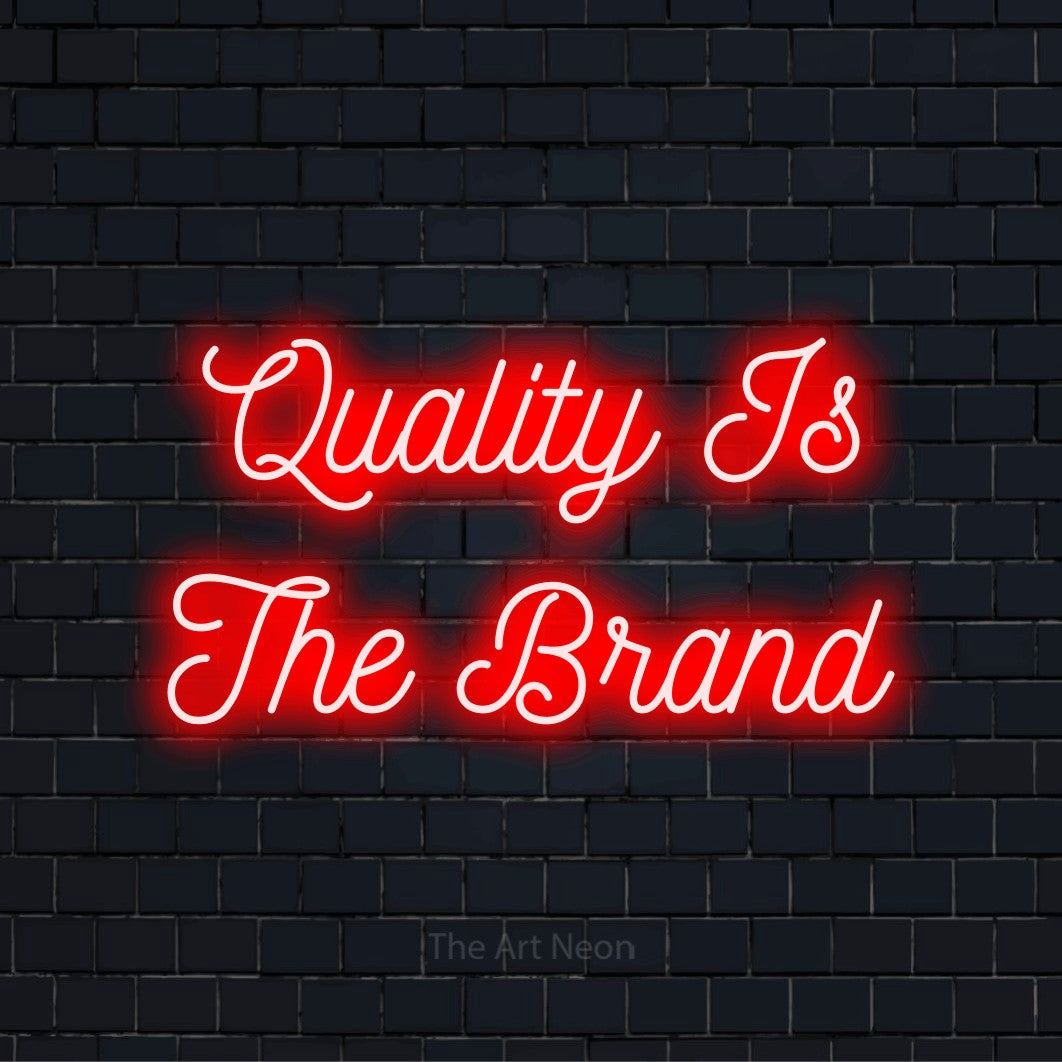 "Quality Is The Brand" LED neon sign on a black brick wall