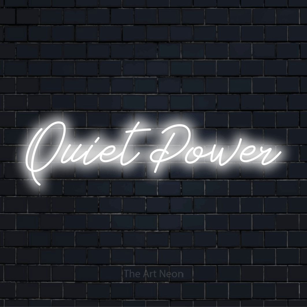 "Quiet Power" neon text design on a black brick wall