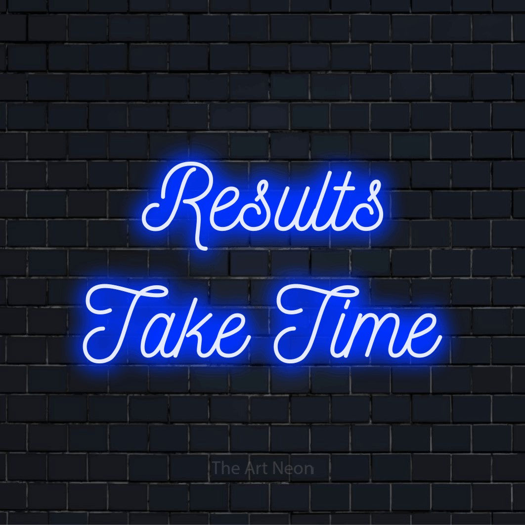 "Results Take Time" script-style LED neon sign on a black brick wall
