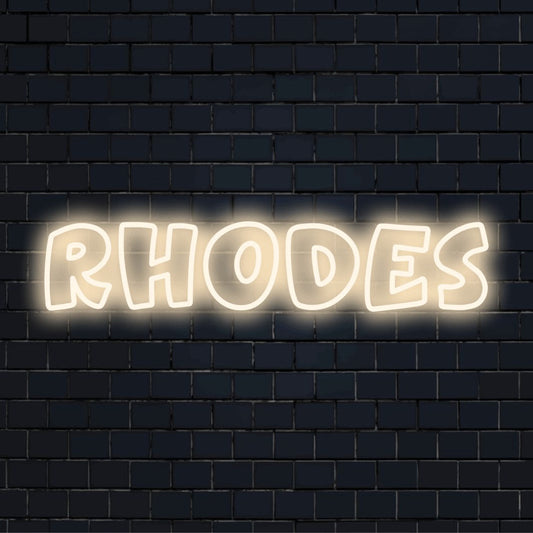 Rhodes Neon Light with bright neon lettering on dark brick background