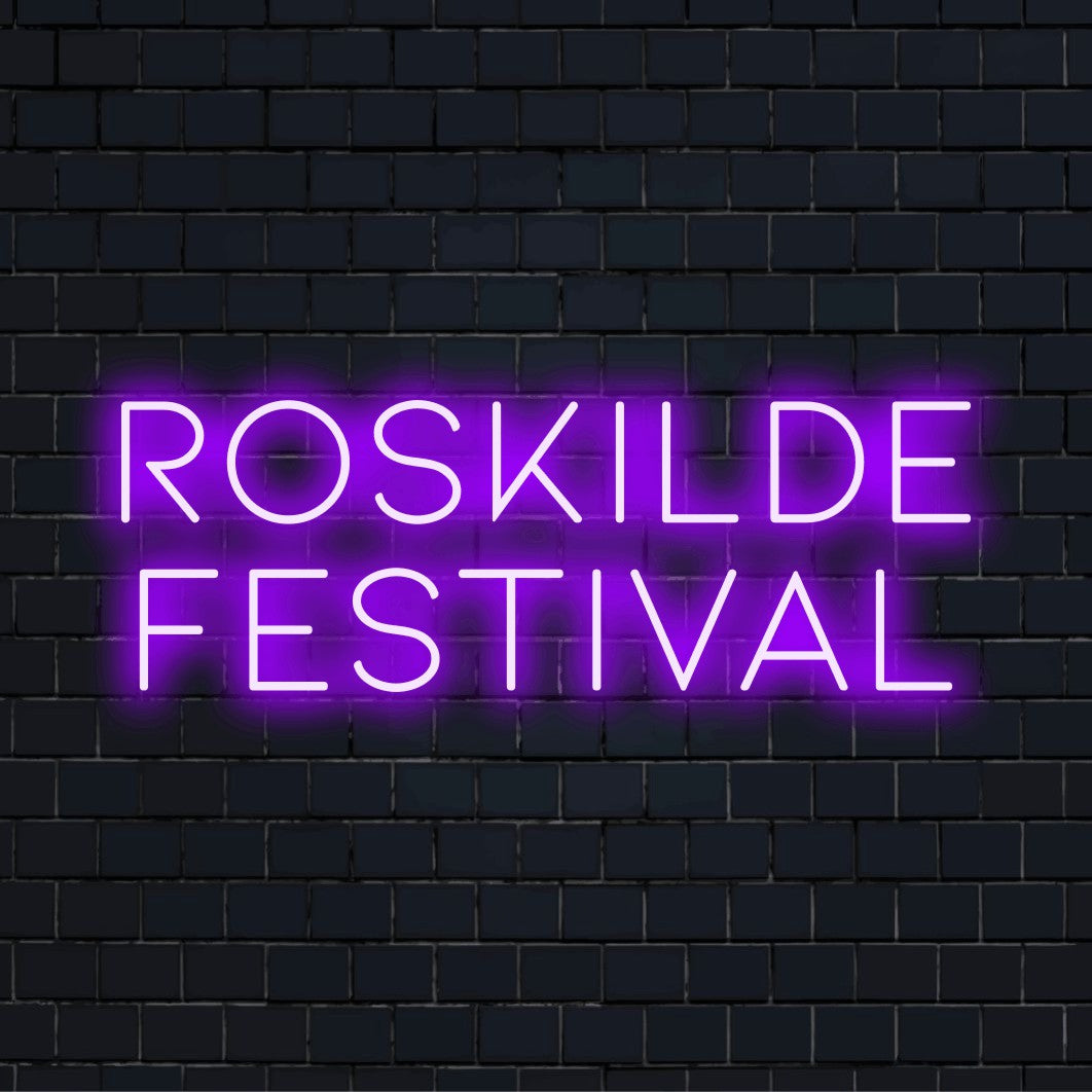 Roskilde Festival Neon Sign, glowing neon text on black brick background