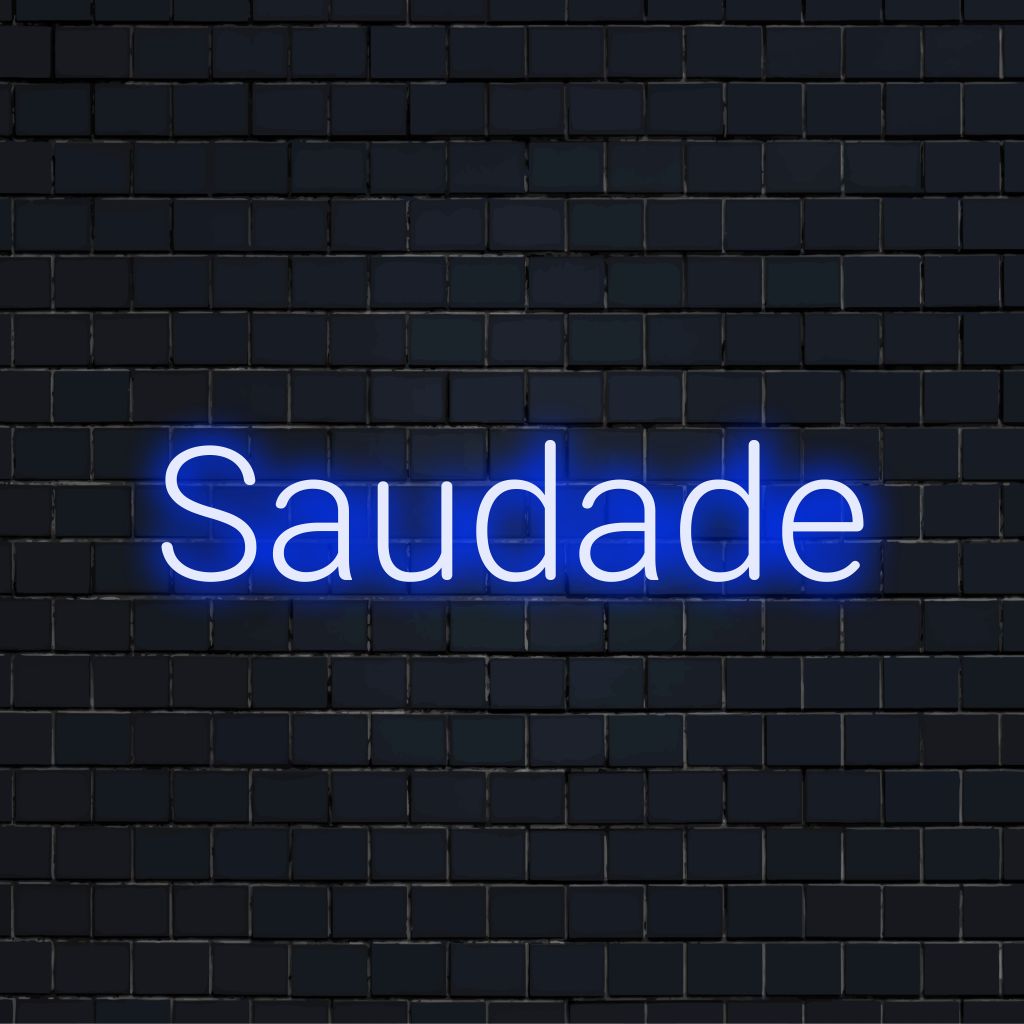 Saudade LED Neon Sign, glowing lettering on dark brick wall