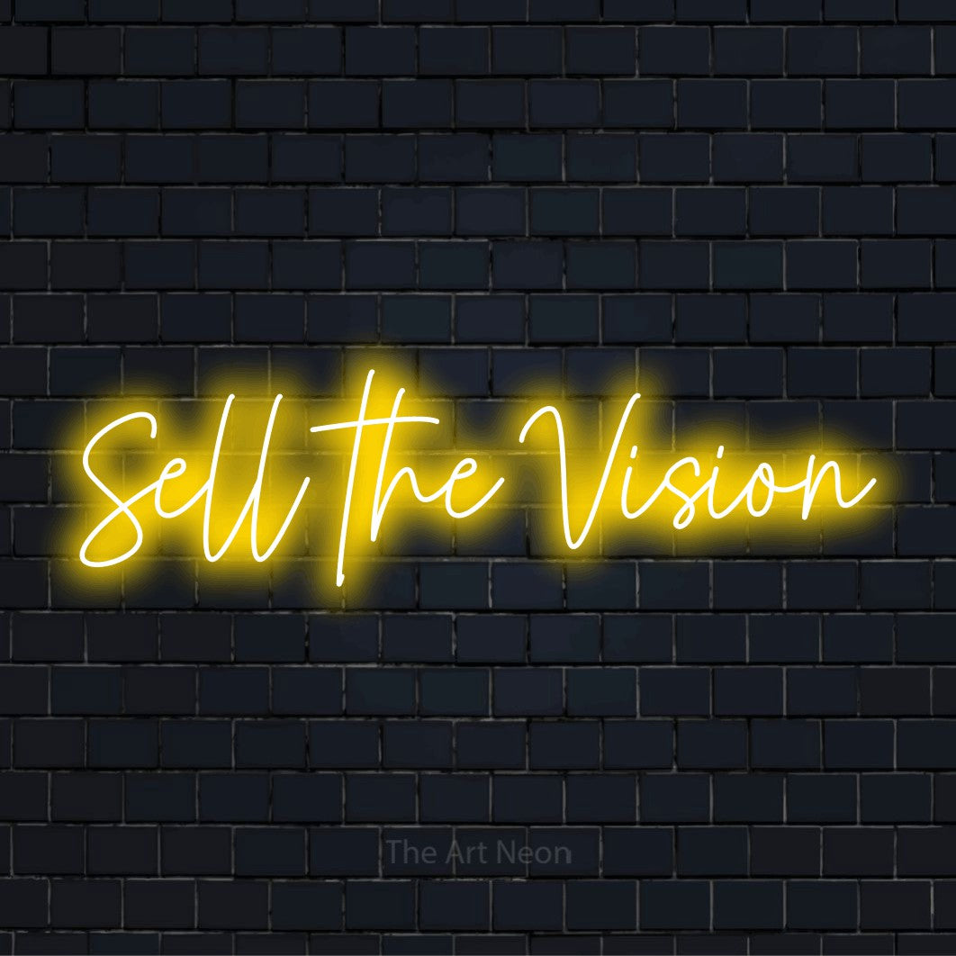 "Sell The Vision" text design with neon effect on a black brick wall
