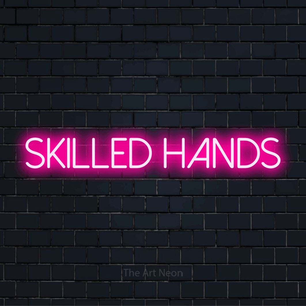 "Skilled Hands" text design with neon effect on a black brick wall