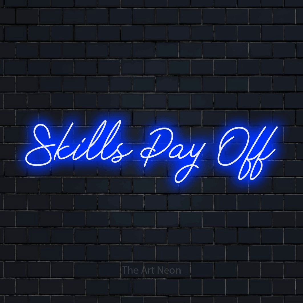 "Skills Pay Off" glowing LED neon sign on a black brick wall