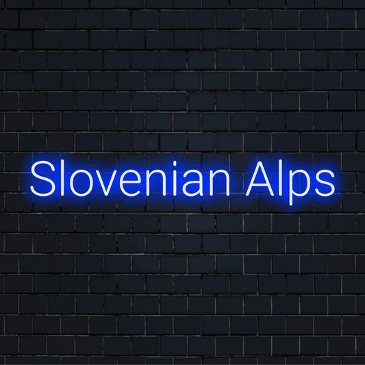Slovenian Alps LED Neon Sign, glowing lettering against black brick wall
