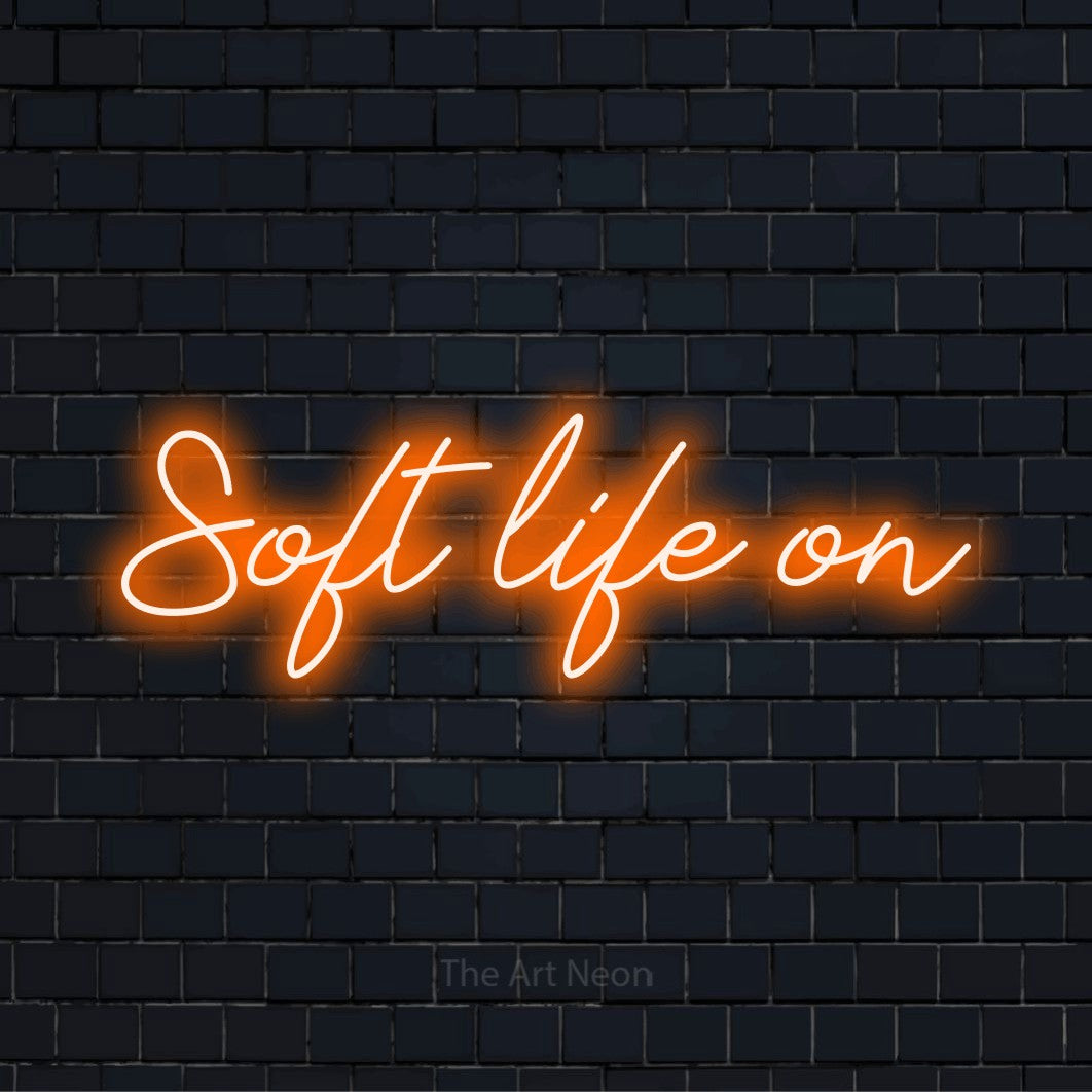 "Soft Life On" LED neon sign on a black brick wall