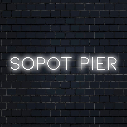 Sopot Pier Neon Light with neon text light on dark brick wall