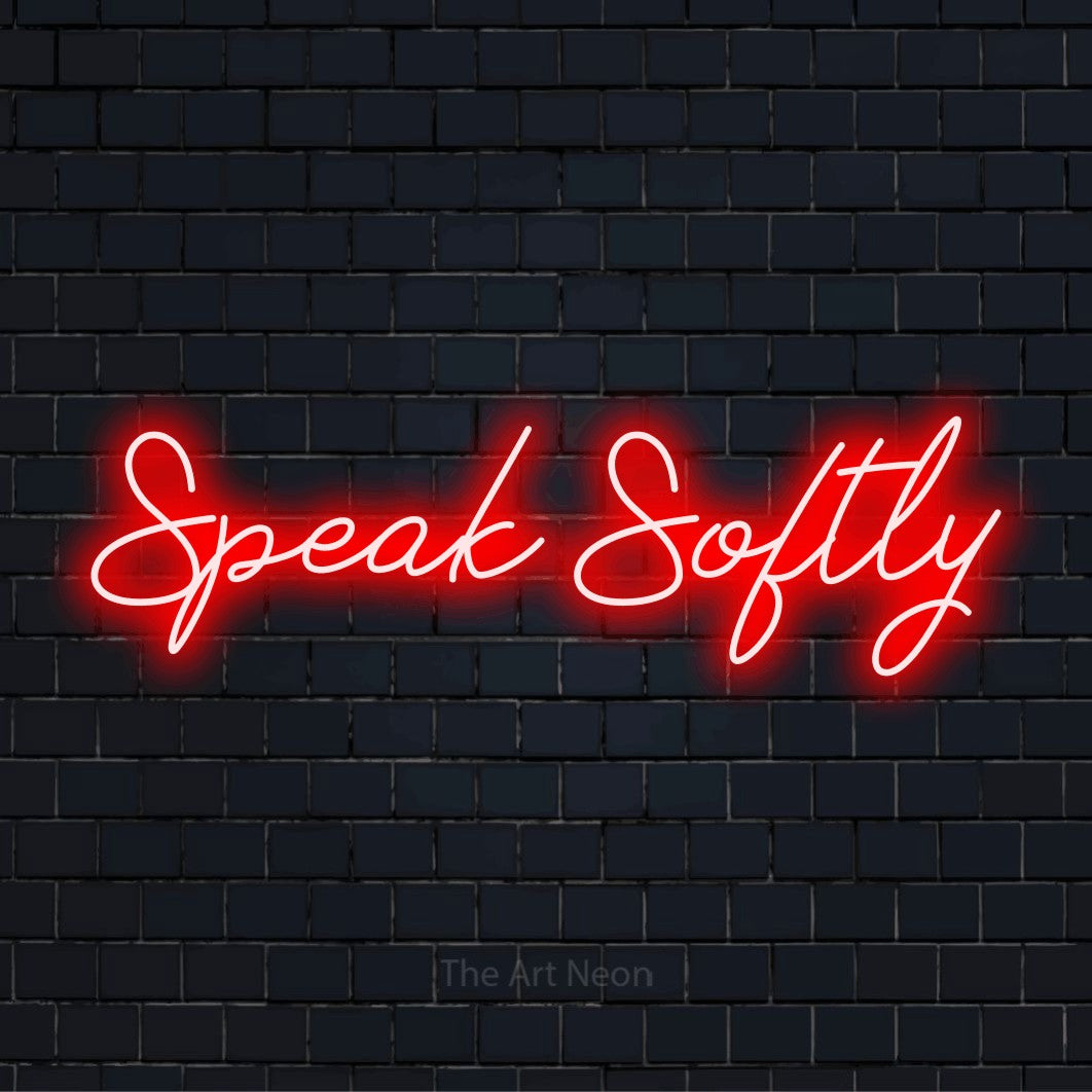 "Speak Softly" text design with neon effect on a black brick wall