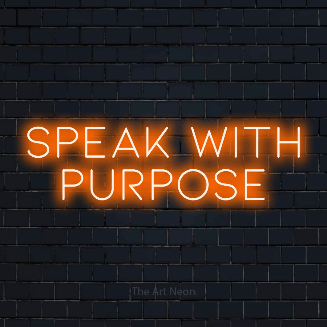"Speak With Purpose" neon text design on a black brick wall