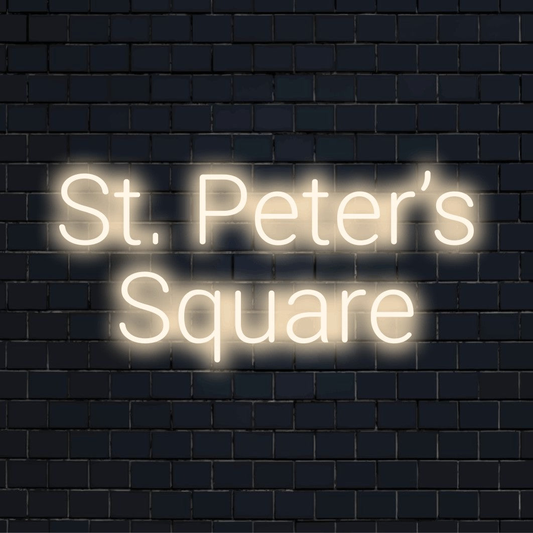 St Peter S Square LED Neon Sign, bright neon lettering on dark brick wall