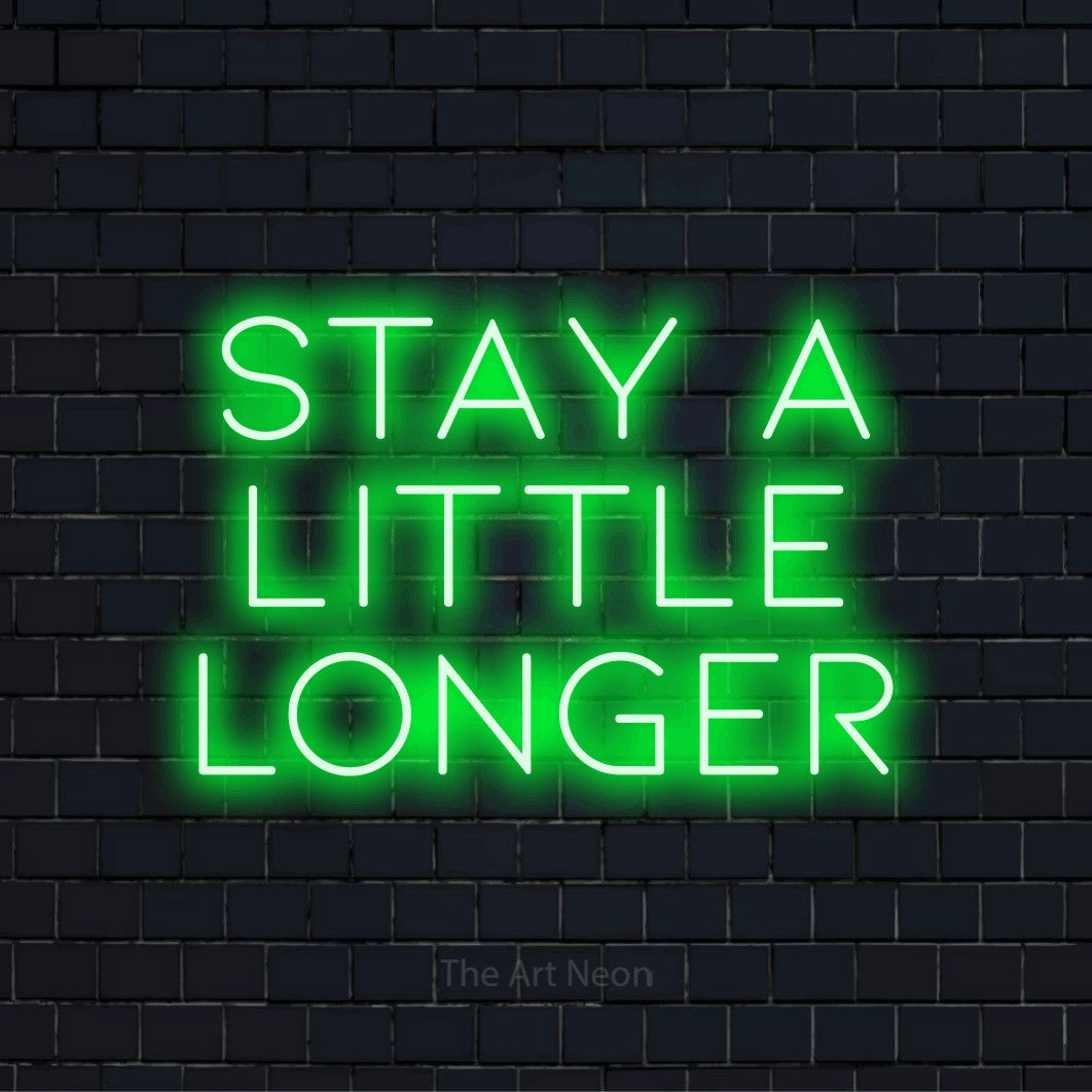 "Stay A Little Longer" neon text design on a black brick wall