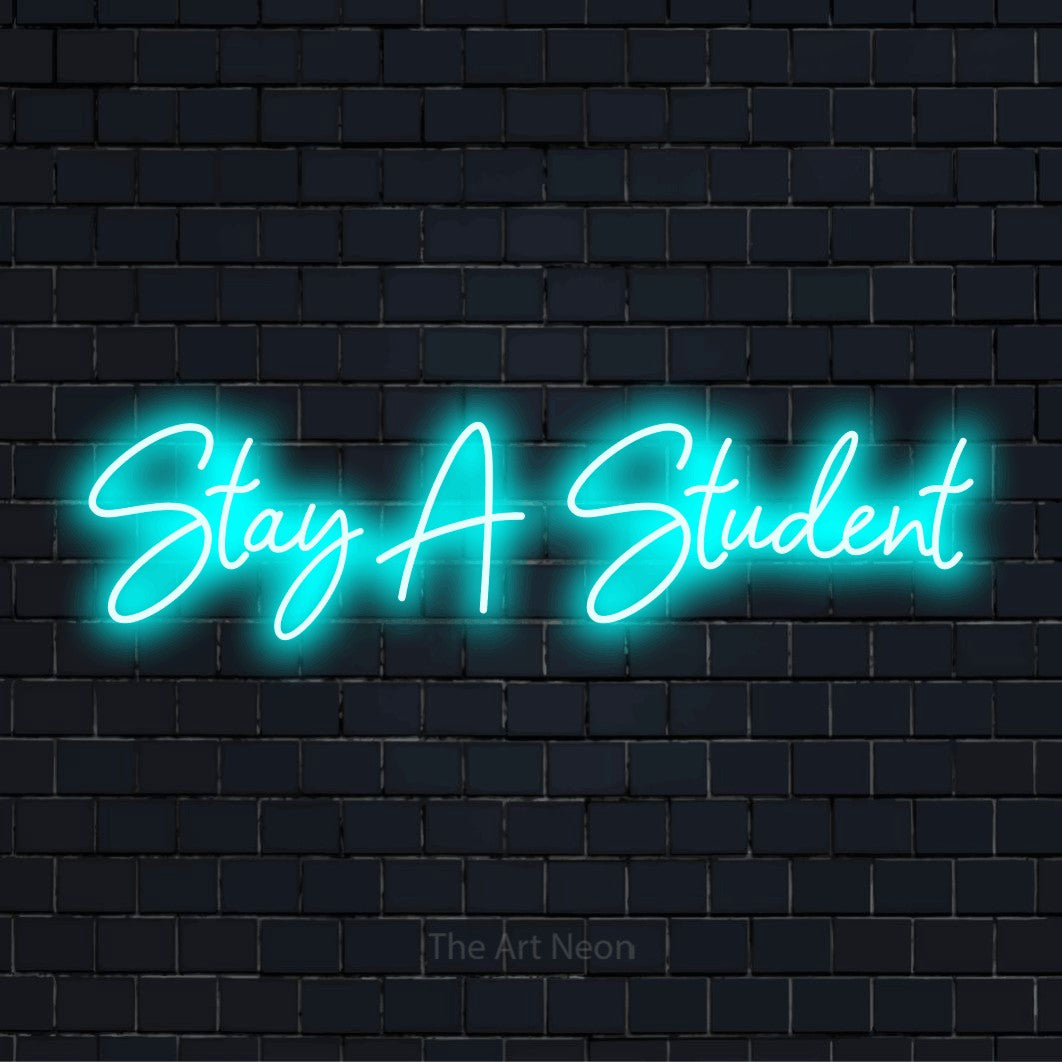 "Stay A Student" LED neon sign on a black brick wall