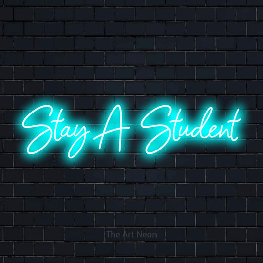 "Stay A Student" LED neon sign on a black brick wall