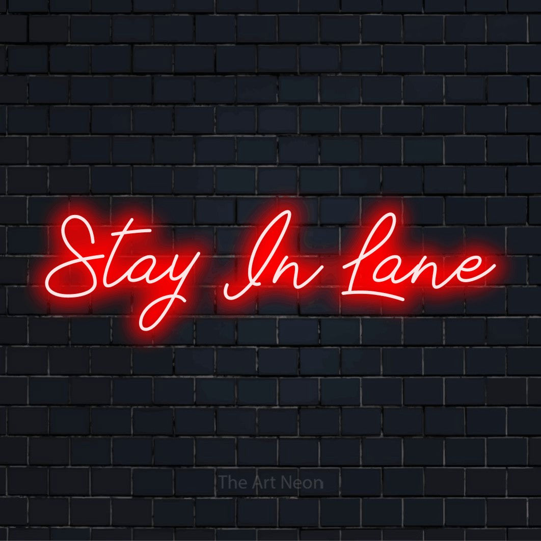 "Stay In Lane" text design with neon effect on a black brick wall