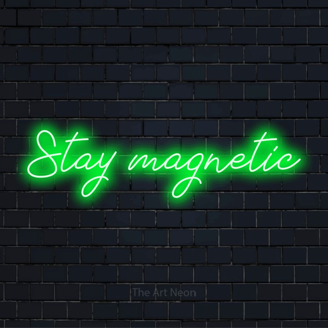"Stay Magnetic" LED neon sign on a black brick wall