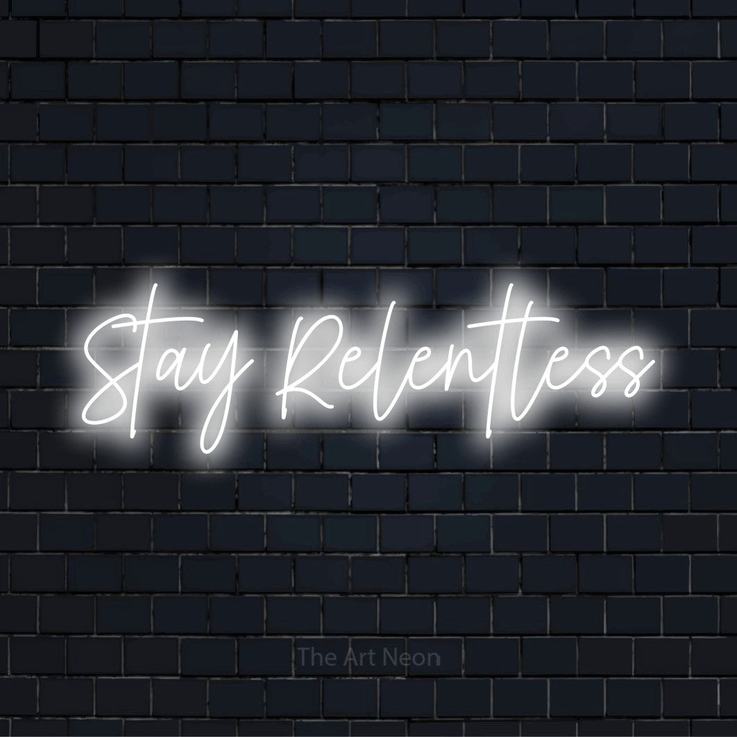 "Stay Relentless" script-style LED neon sign on a black brick wall