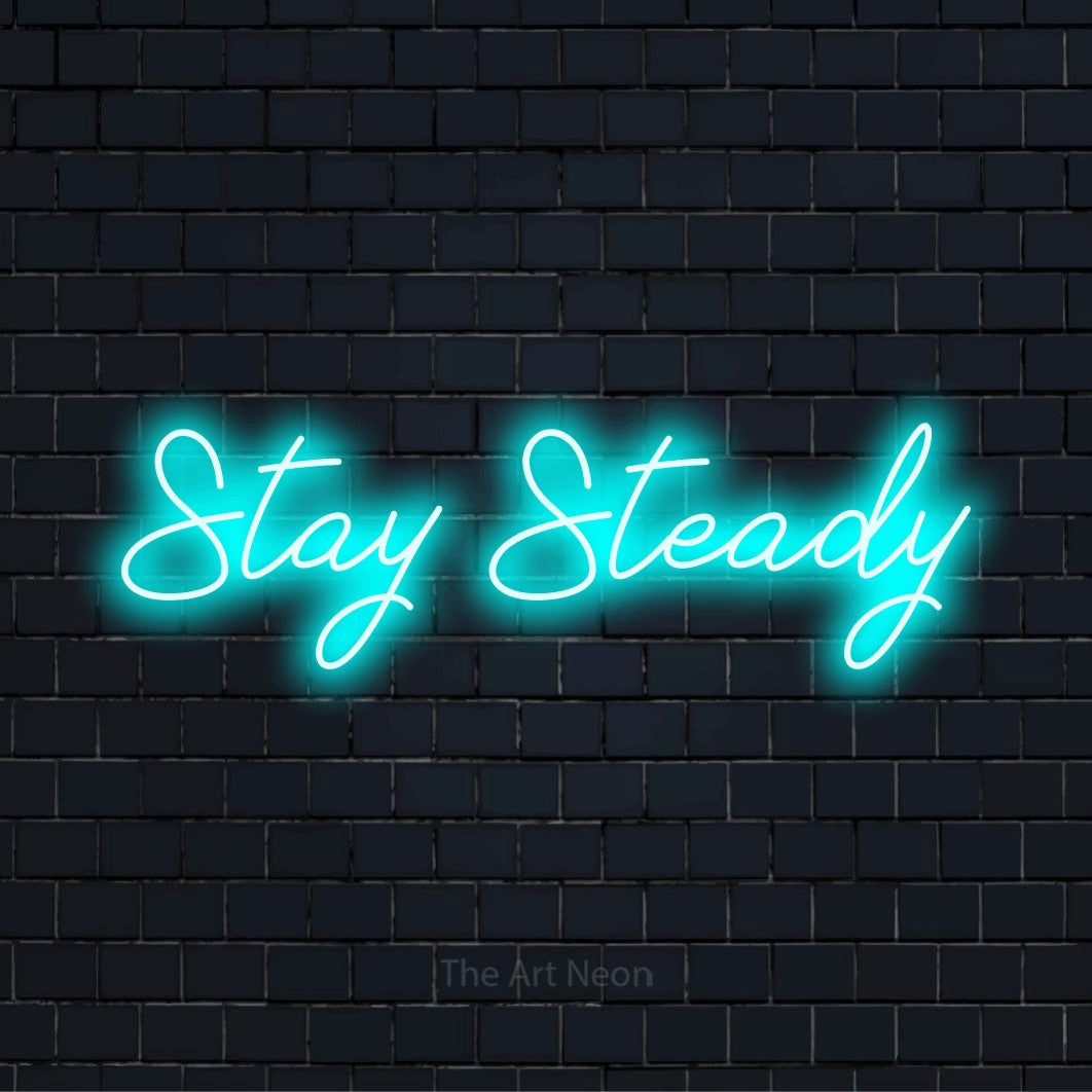 "Stay Steady" glowing LED neon sign on a black brick wall