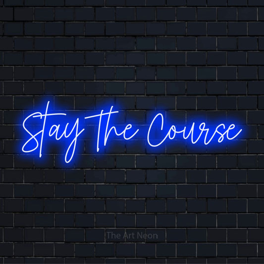 "Stay The Course" script-style LED neon sign on a black brick wall