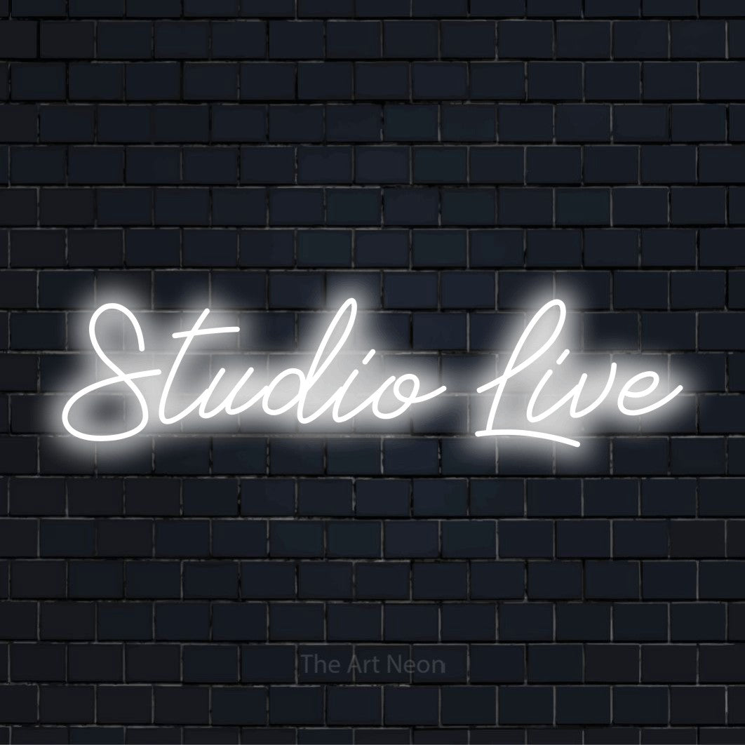 "Studio Live" LED neon sign on a black brick wall