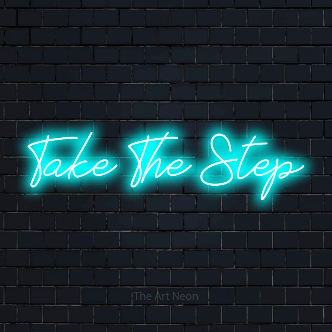 "Take The Step" LED neon sign on a black brick wall