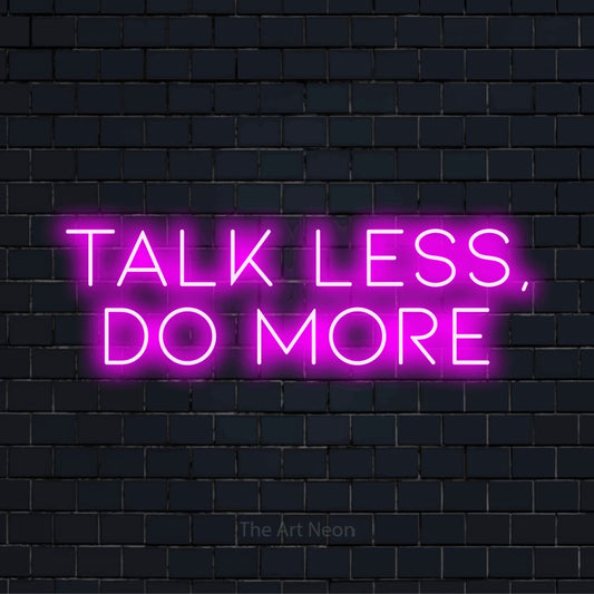 "Talk Less, Do More" neon text design on a black brick wall