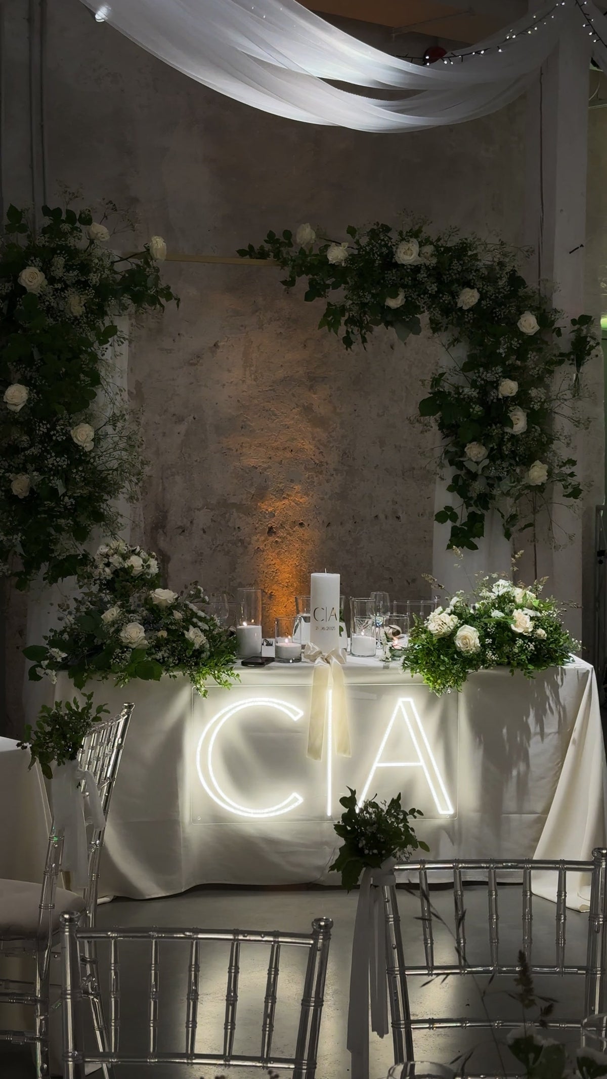 Warm-white C and A initials LED neon displayed on a table for a wedding celebration.