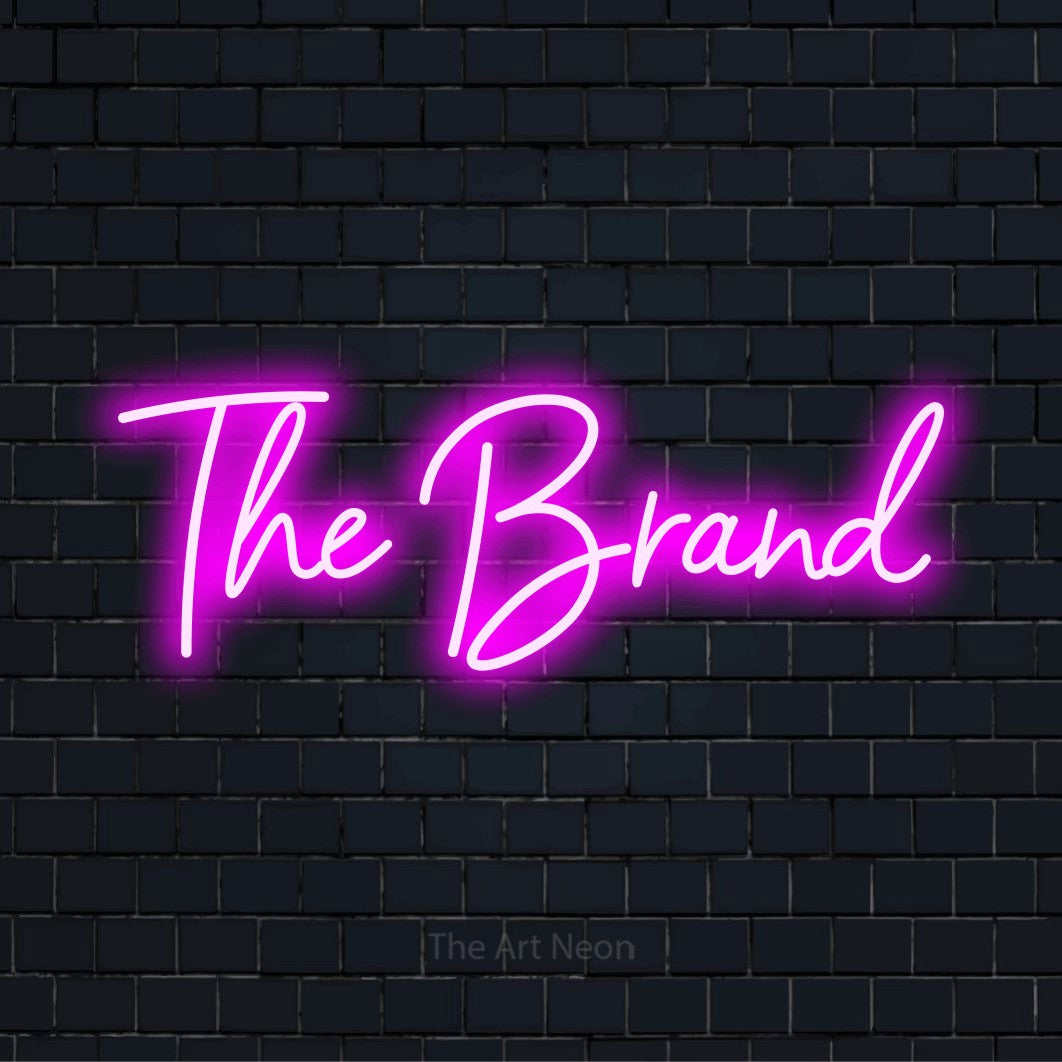 "The Brand" LED neon sign on a black brick wall