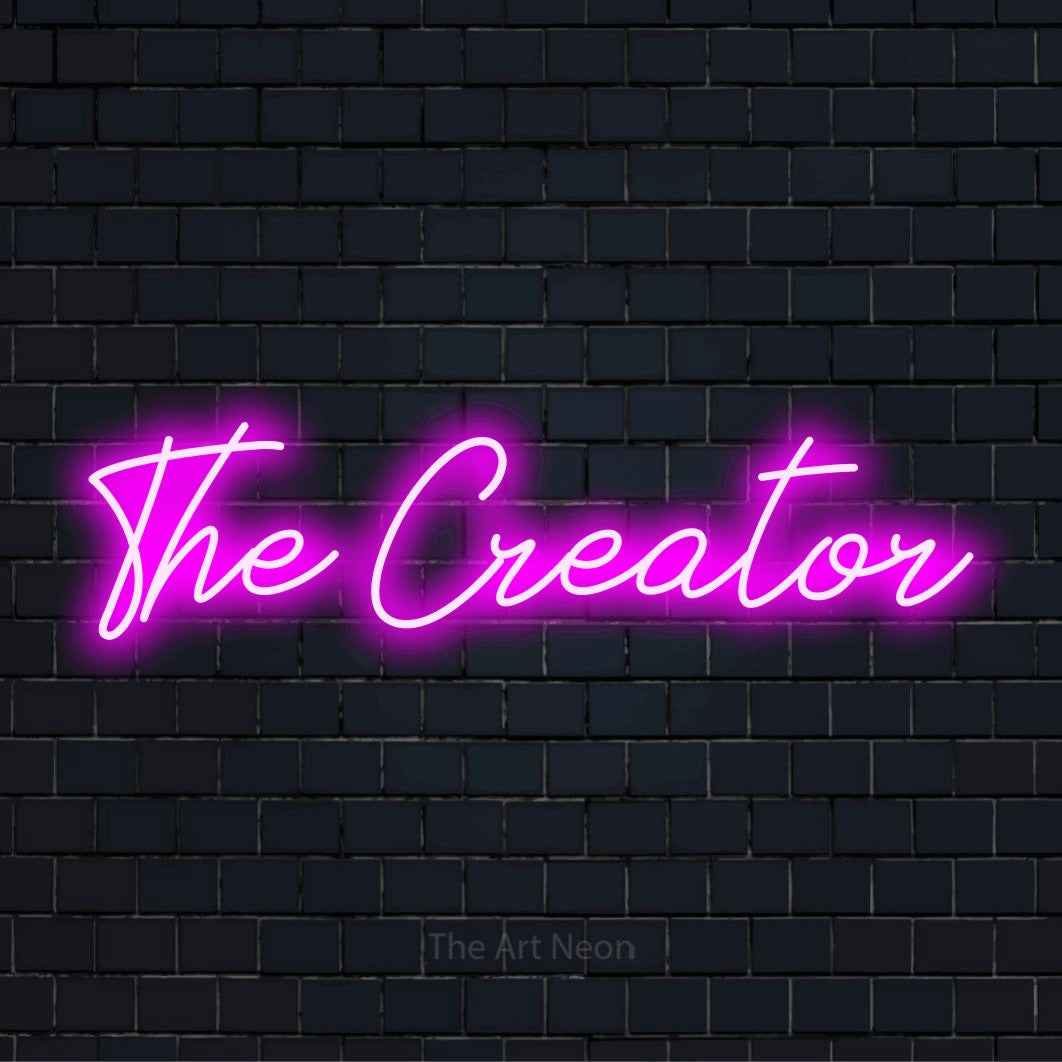 "The Creator" neon text design on a black brick wall