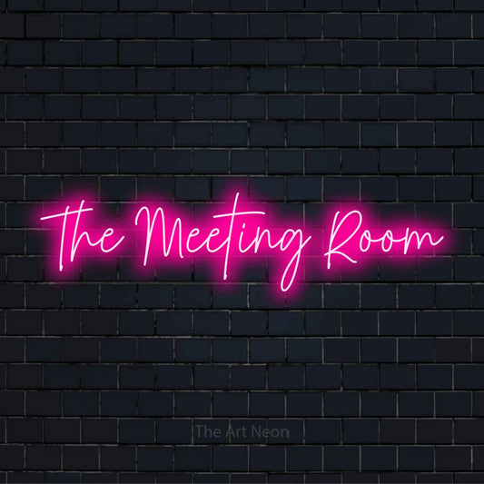 "The Meeting Room" script-style LED neon sign on a black brick wall