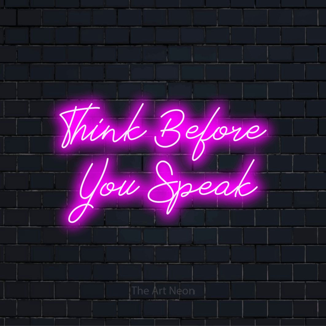 "Think Before You Speak" neon text design on a black brick wall