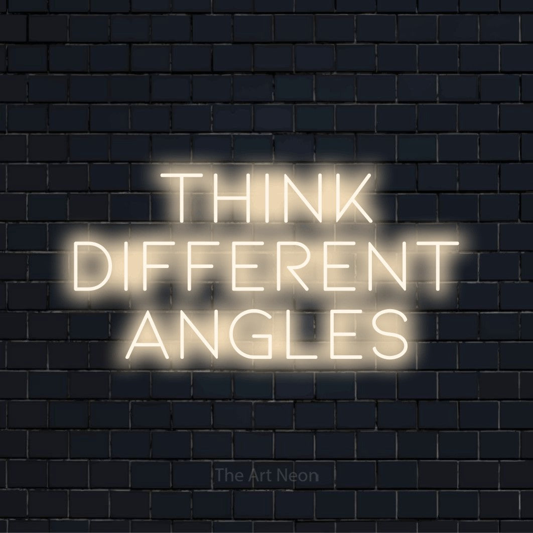 "Think Different Angles" script-style LED neon sign on a black brick wall