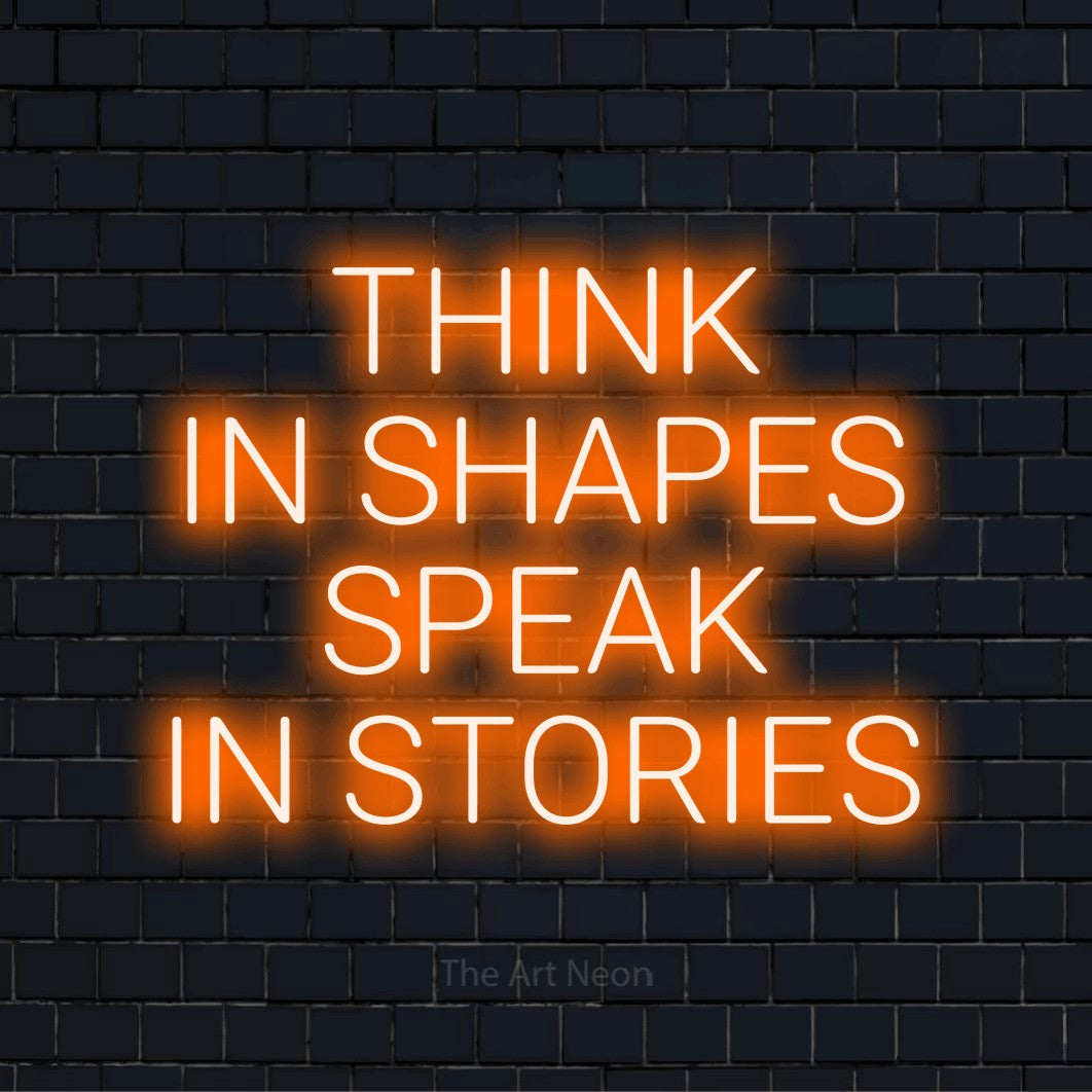 "Think In Shapes Speak In Stories" text design with neon effect on a black brick wall