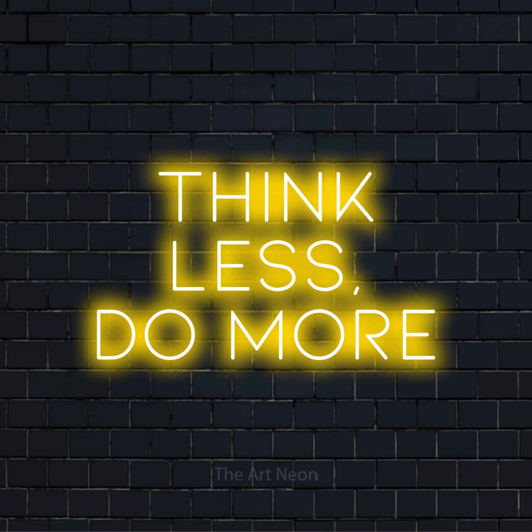 "Think Less, Do More" glowing LED neon sign on a black brick wall